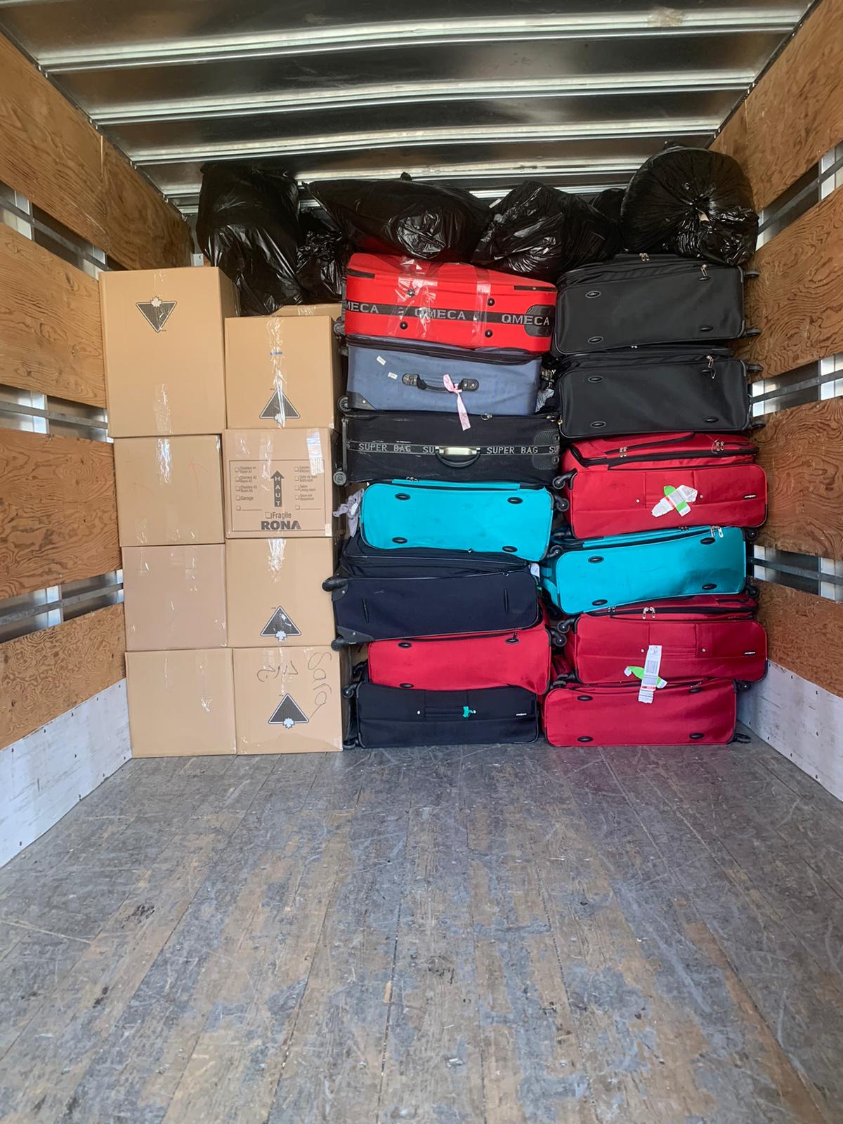 alt="A truck well packed with boxes and bags"